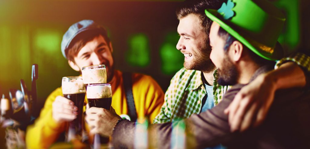 Three friends enjoying St. Patrick's Day at a bar